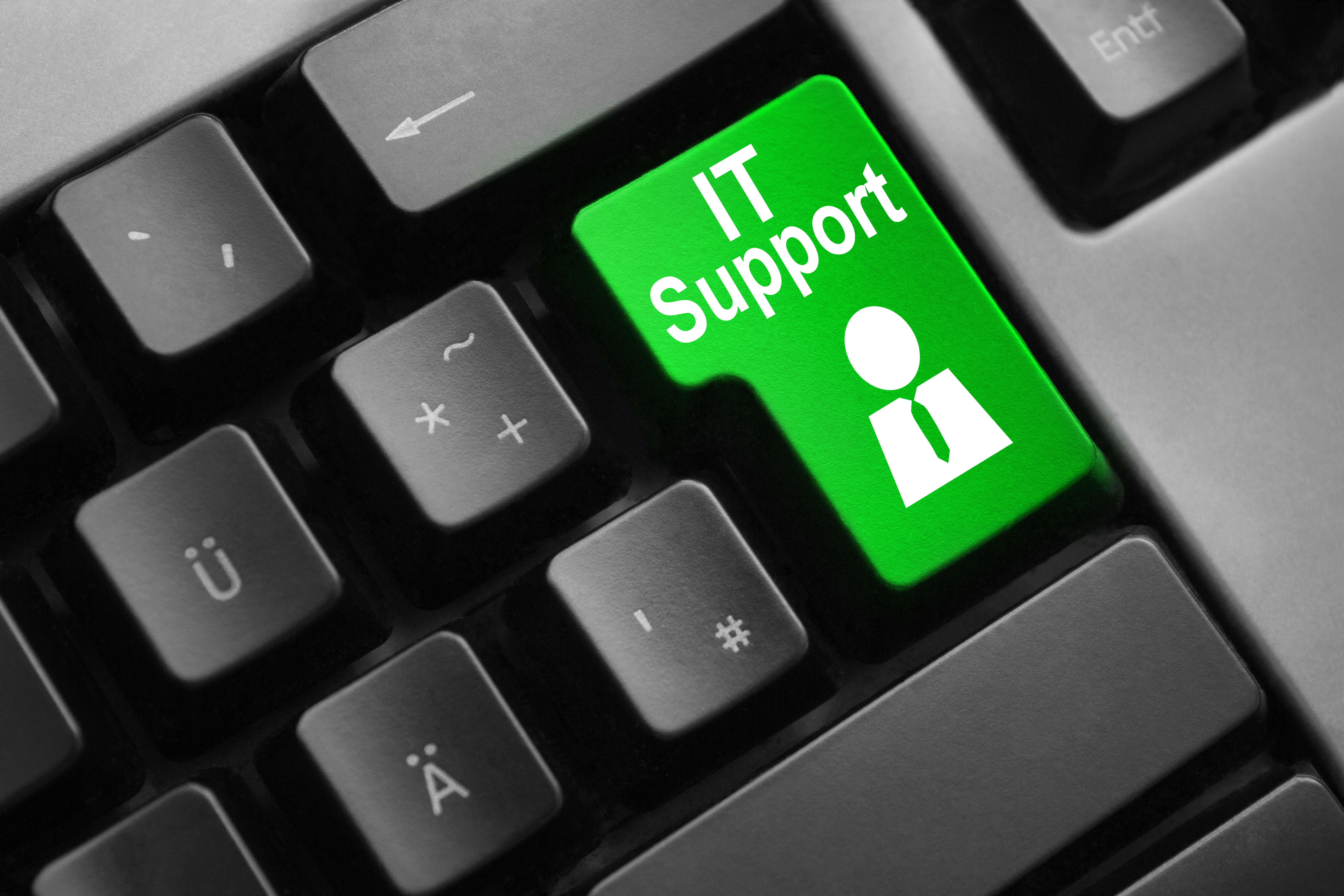 Dark gray keyboard with green button IT support symbol.