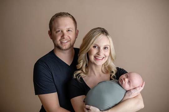  Adam Szember and his wife with their new born son